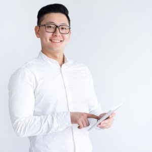 Free Photo Smiling asian man using tablet computer