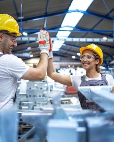 Free Photo _ Factory workers greeting each other for successful teamwork