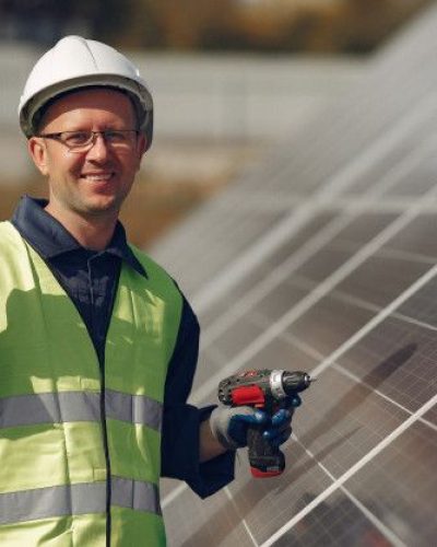 Free Photo _ Man with white helmet near a solar panel