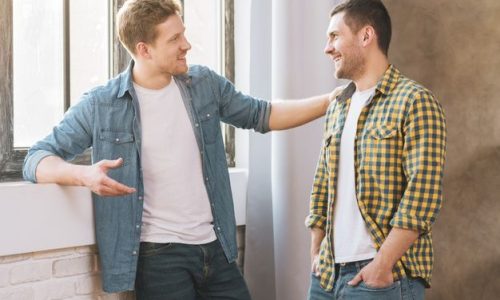Free Photo _ Two smiling young men talking to each other