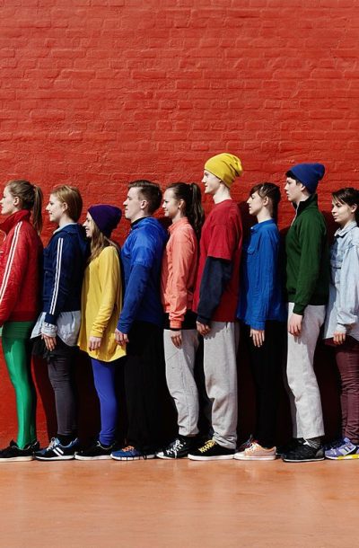 Young people standing in a line looking the same way_
